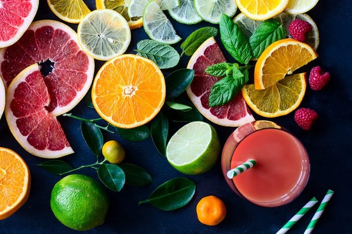 Citrus juice and slices of orange, grapefruit, lemon. Vitamin C. Black background