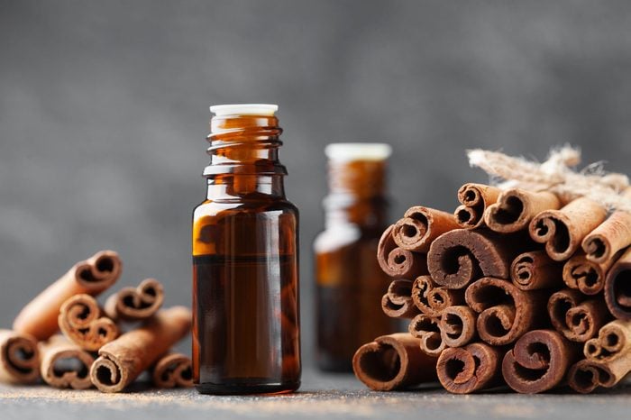 Cinnamon essential oil for spa, aromatherapy, wellness, medical background.
