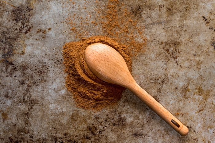 Ground Cinnamon Spilled from a Teaspoon