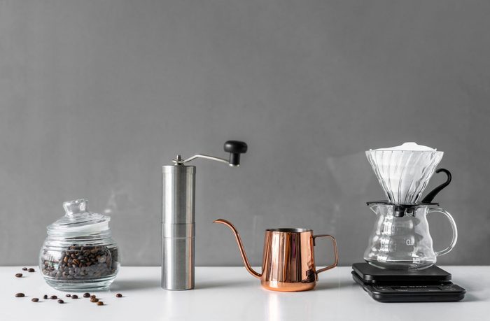 Coffee brewing tools in modern style for homemade on white table and grey background with copy space from home kitchen.