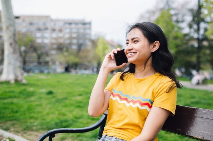 Young Asian Woman talking on her phone