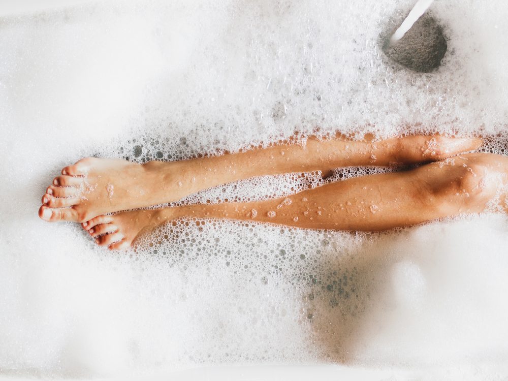 Woman's legs in bubble bath