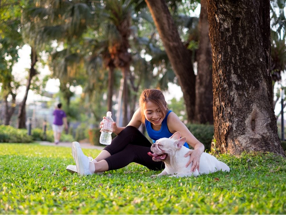 Asian woman with her dog at the park