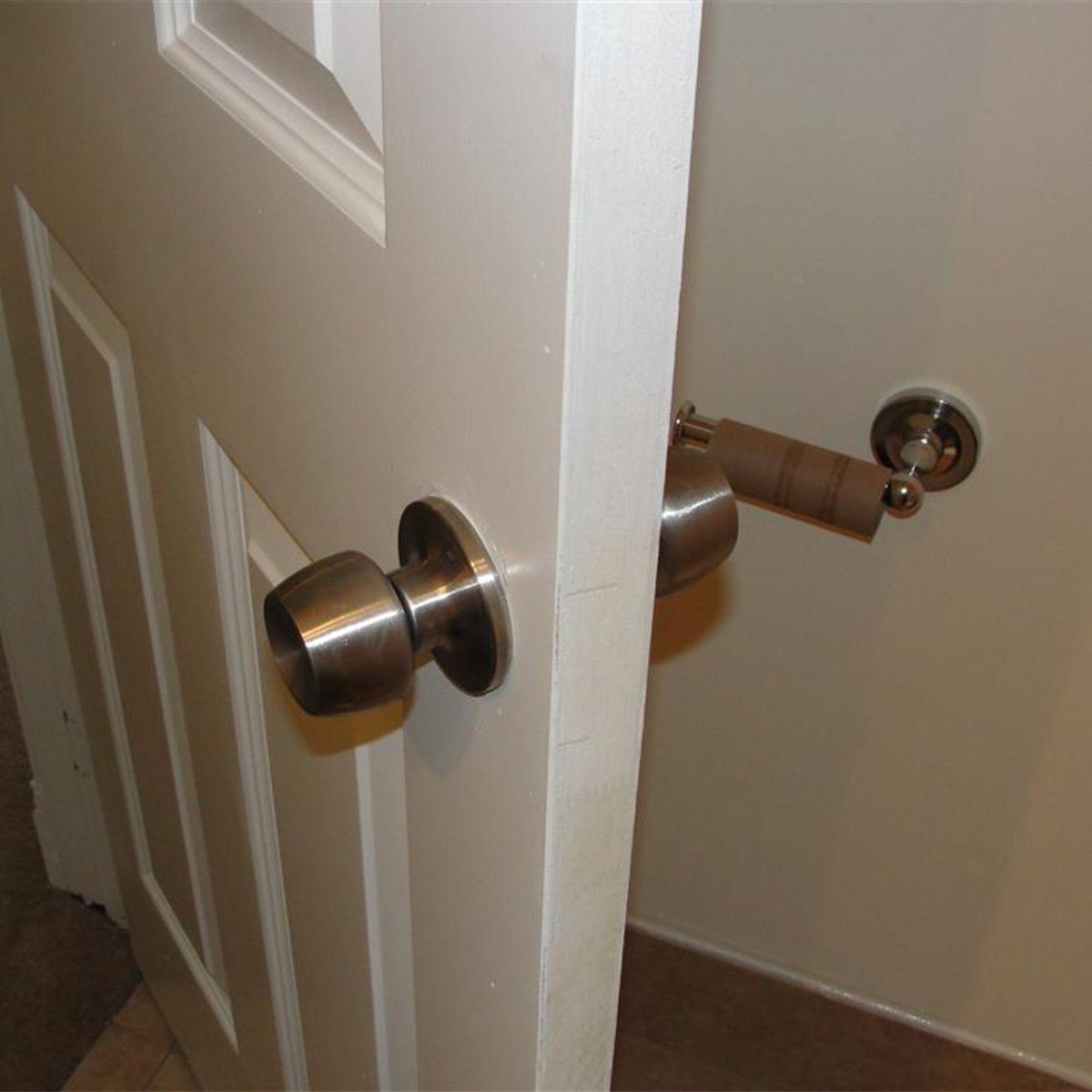 toilet paper holder behind door