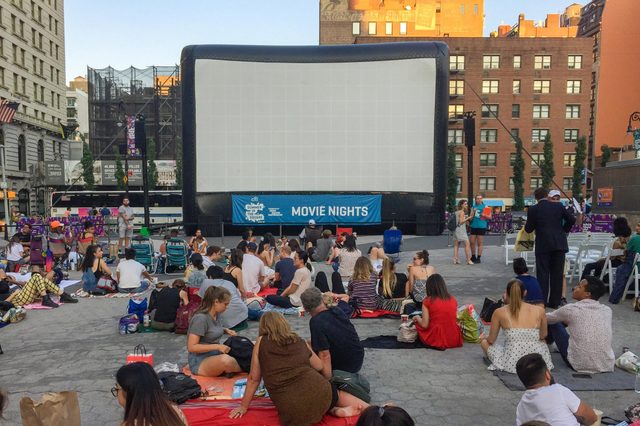 People are waiting to see a movie in Union Square in summer, New York City.