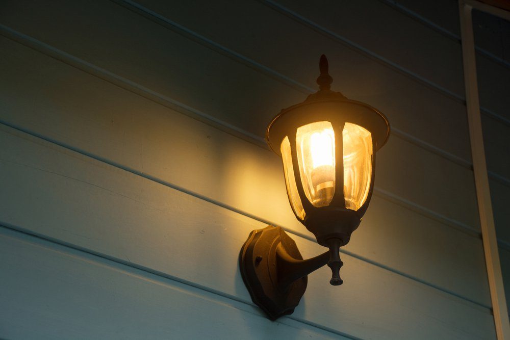Warm light of external lamps on the house wall