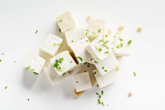 Soy Bean curd tofu with greens on white background Non-dairy alternative substitute for cheese