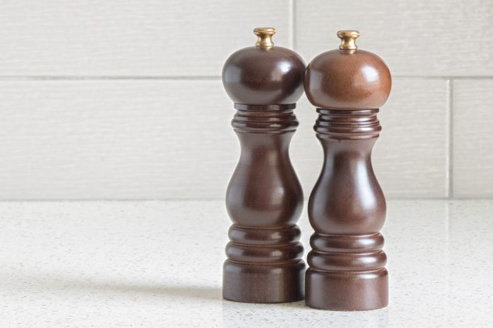  Wooden salt and pepper shakers on granite counter-top