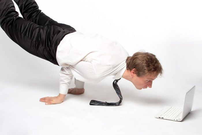 Young businessman yoga before an open notebook