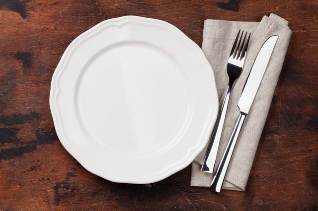 Table setting. Empty plate, knife, fork and napkin. Top view and flat lay with copy space