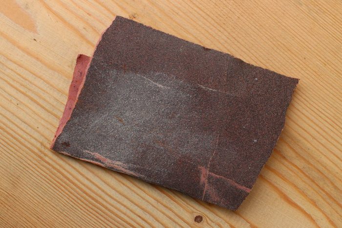 Sandpaper on a wooden background closeup