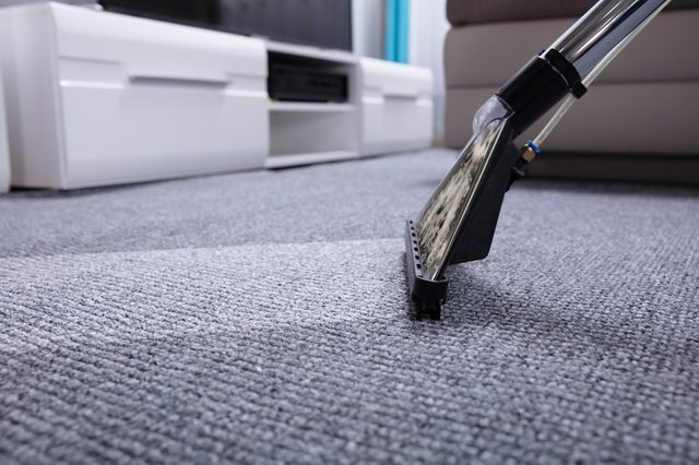 Close-up Of A Vacuum Cleaner Over Grey Carpet