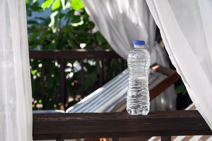Clear Plastic bottle with water standing on a terrace