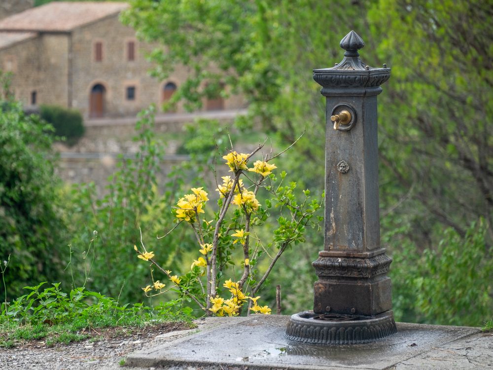 Old public water fountain in Italy