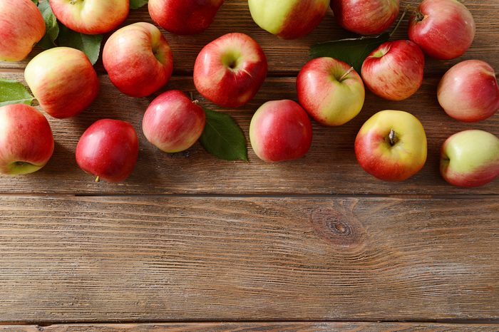 Sweet apples on wooden background