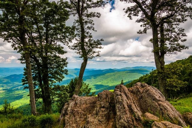 Boulders, trees, and view of the Blue Ridge at an overlook on Skyline Drive in Shenandoah National Park, Virginia.