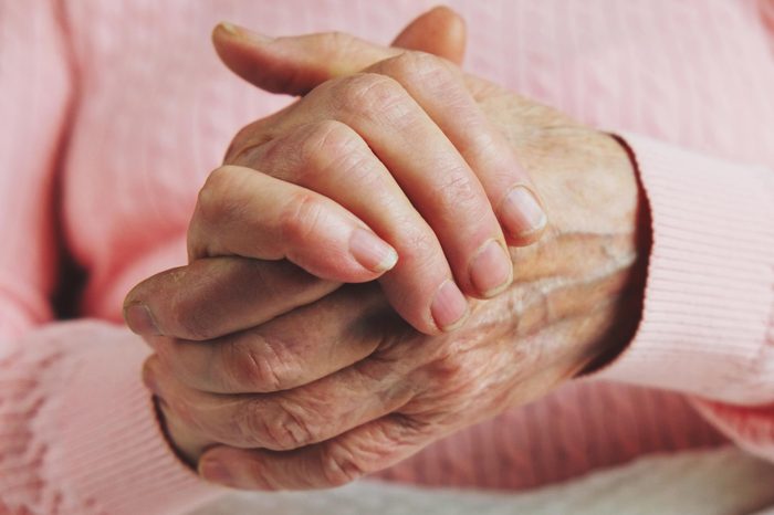 closeup of an elderly person clasping her hands