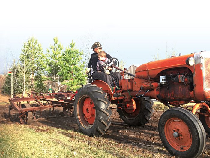 For the love of farming - father and son on tractor
