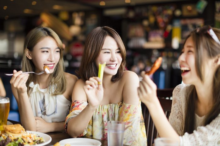 young woman Friends Enjoying Meal in the Restaurant