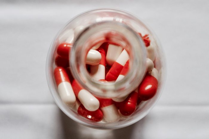 top down view of capsules in a glass bottle