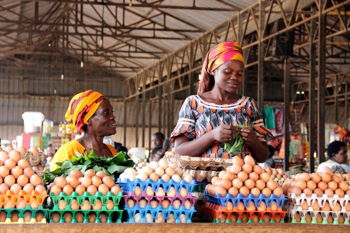 Rwandan women selling eggs to people visiting the Kimironko market in Rwanda's capital city.