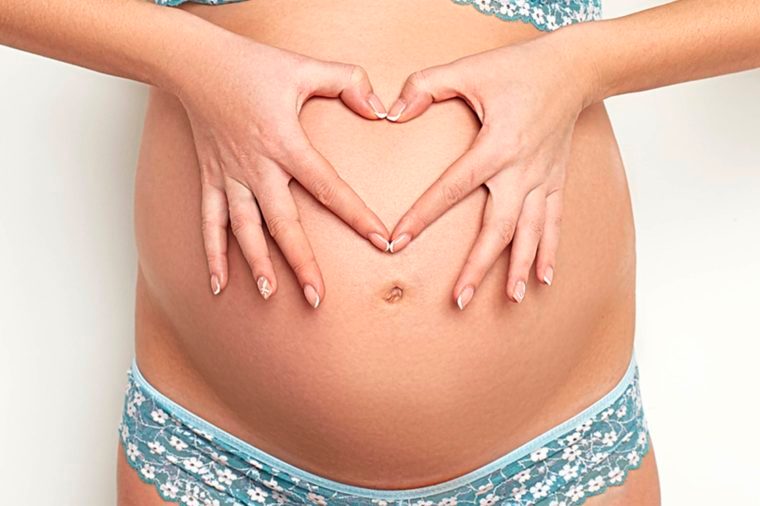 Pregnant woman's bare belly button
