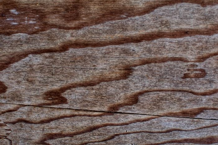 Watermark on texture of the old wooden cutting board background.