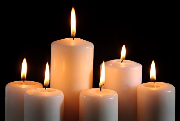 six candles on a black background.