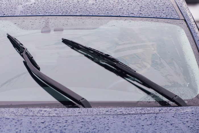 view of the car windshield wipers in the rain