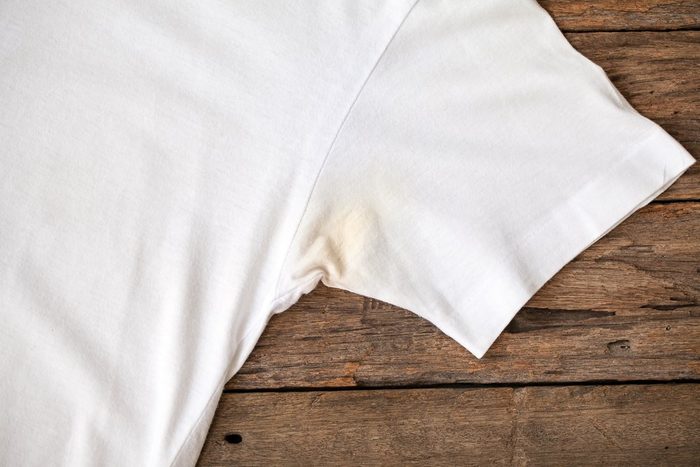 Shirts dirty caused by roll- on deodorant on wooden background