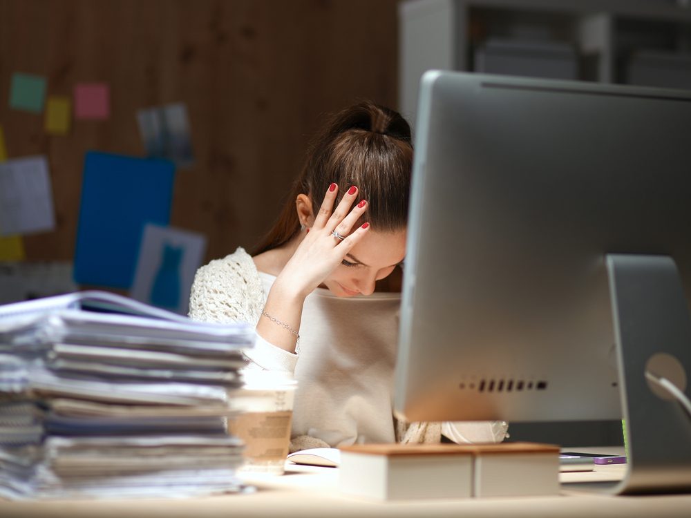 Stressed woman at her desk in office