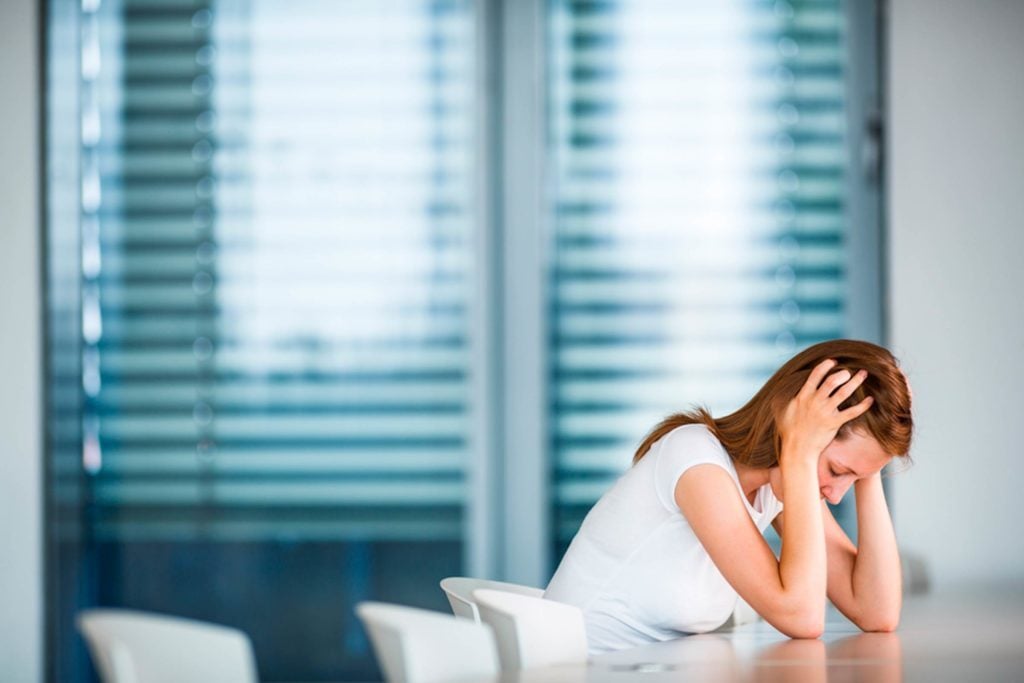 Stressed woman in boardroom