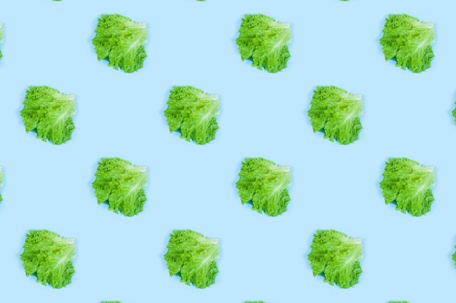 Pattern of fresh Green lettuce on blue background. Top view. Summer concept. Collage