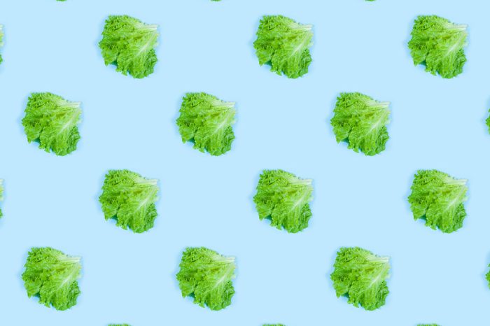 Pattern of fresh Green lettuce on blue background. Top view. Summer concept. Collage