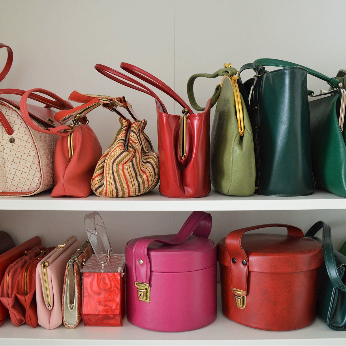 Various purses of all colors on a shelf