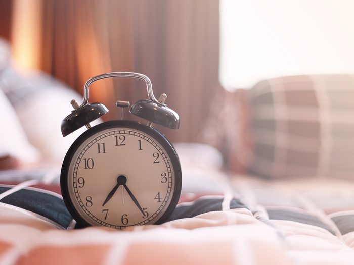 Daylight saving time - vintage clock on bed