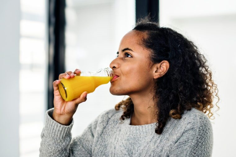 Attractive woman drinking orange juice