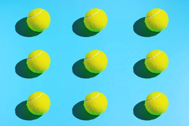 Symmetrical tennis balls on a blue background. Sports background.