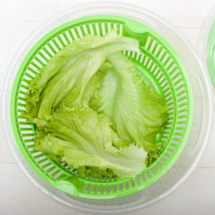 Close up of salad spinner with lettuce on white table; Shutterstock ID 229211386; Job (TFH, TOH, RD, BNB, CWM, CM): TOH