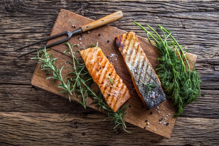 Two grilled salmon fillets, skin-on