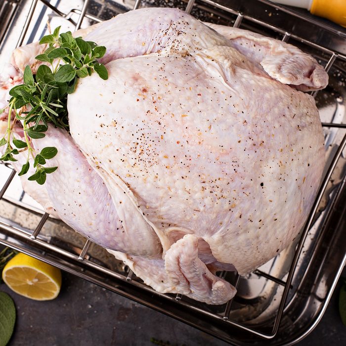Cooking Thanksgiving or Christmas turkey in a roasting pan with lemons and herbs overhead view; Shutterstock ID 737627689; Job (TFH, TOH, RD, BNB, CWM, CM): TOH