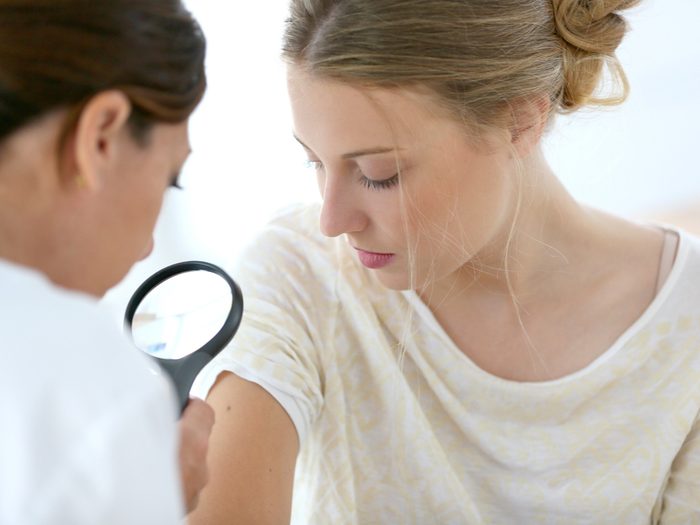 Skin changes - woman being examined by dermatologist