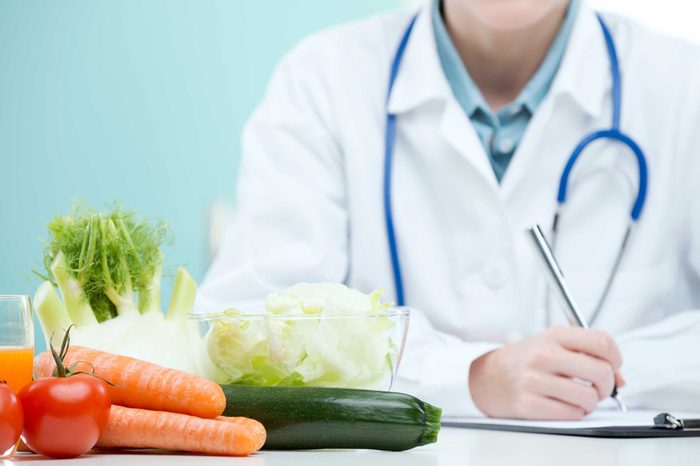 Doctor writing prescription for healthy diet