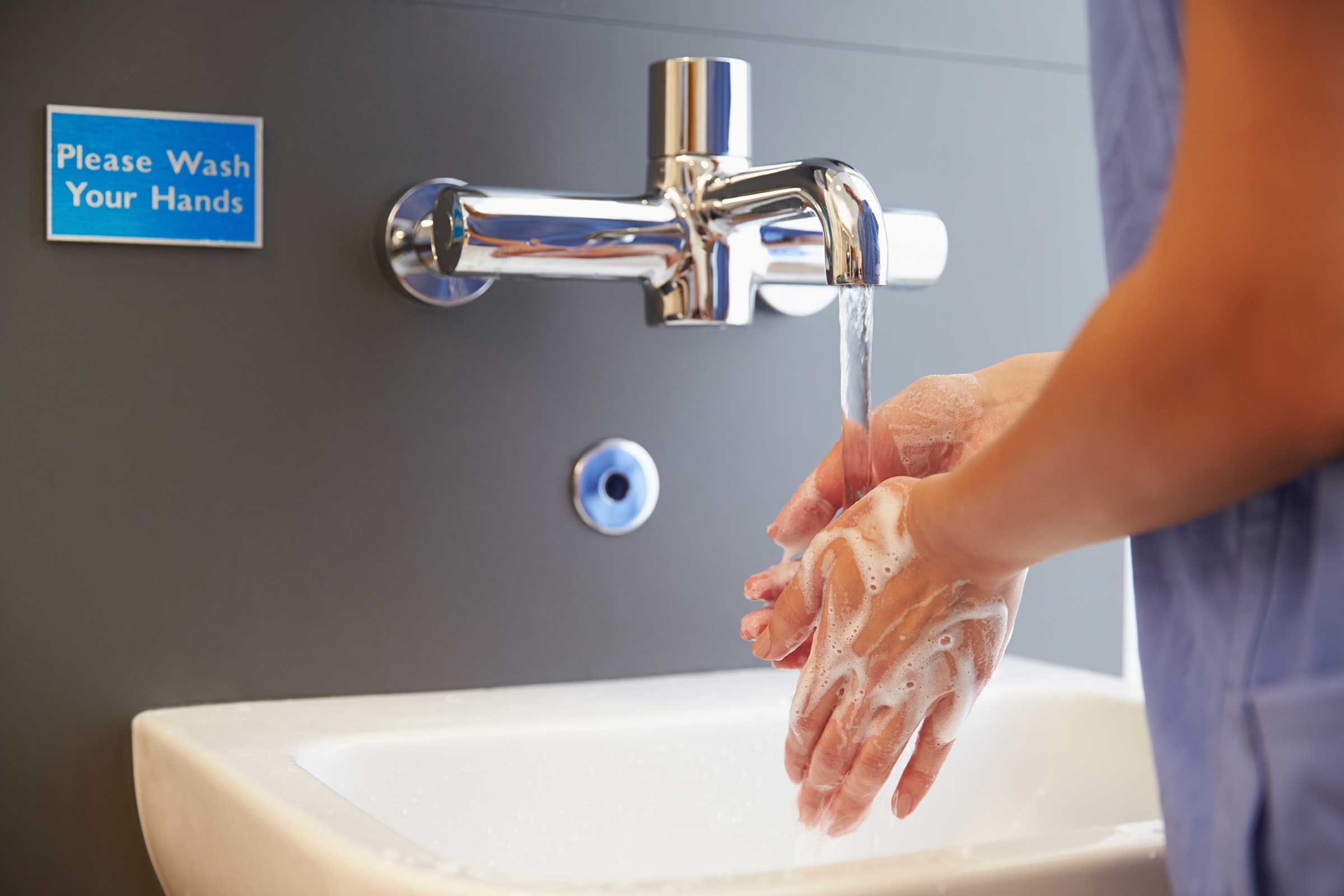 Washing hands in public restroom