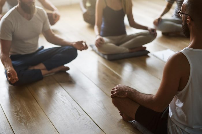 yoga class sitting cross-legged on the floor