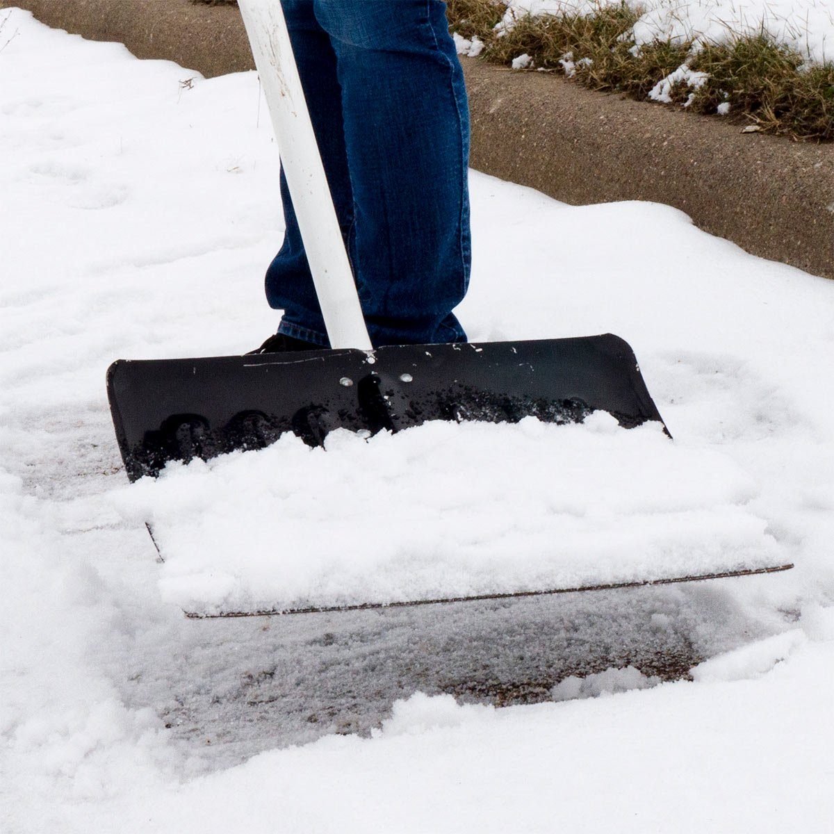 scooping snow with car wax coated snow shovel
