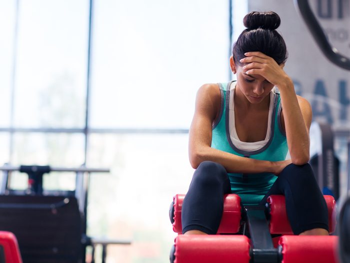 Woman at the gym exhausted