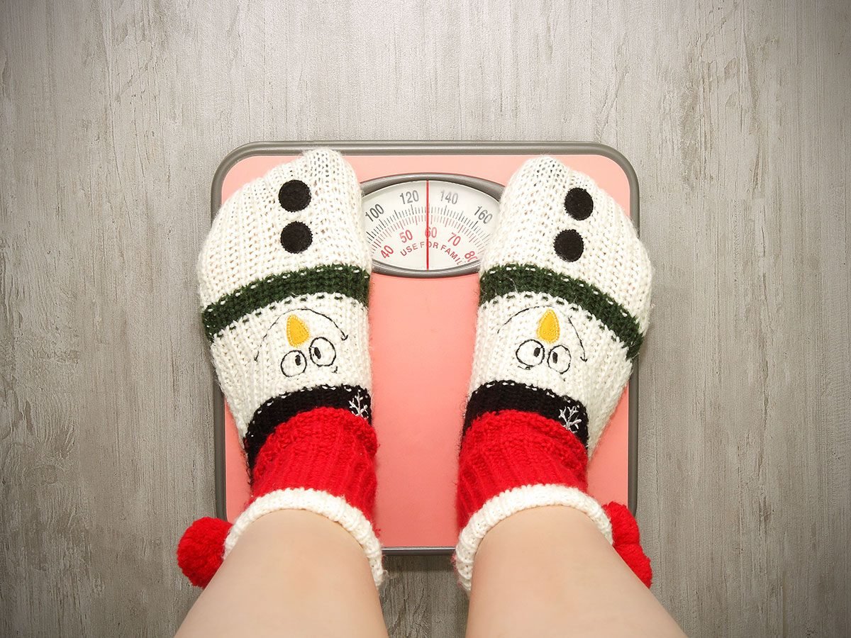 Holiday disasters - Christmas overeating weigh on scale