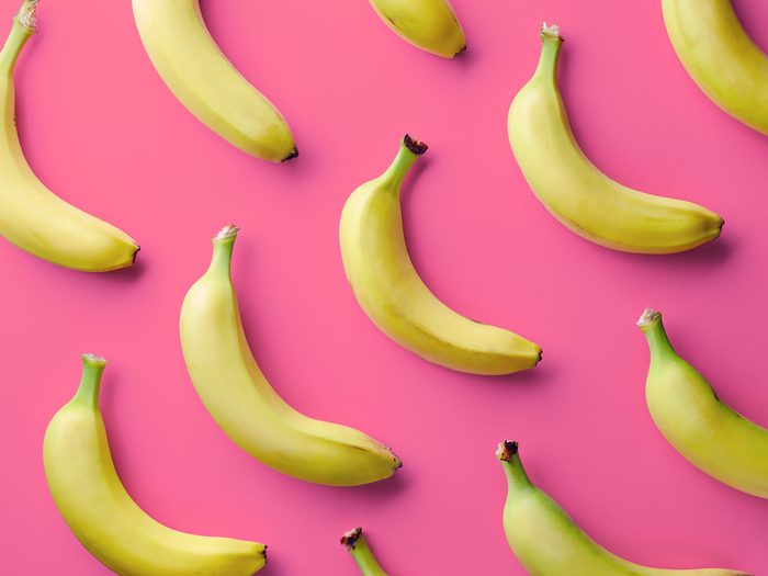 Yellow bananas against pink background