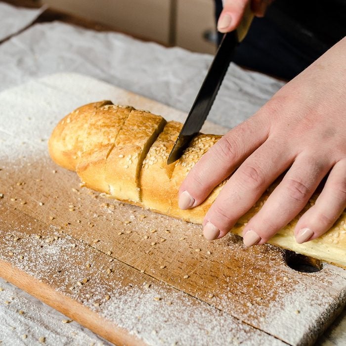 Sliced bread on a wooden board.; Shutterstock ID 1022471170; Job (TFH, TOH, RD, BNB, CWM, CM): TOH